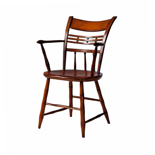 Antique Windsor armchair featuring a bamboo-style turned frame and a distinct ball-decorated bar back.