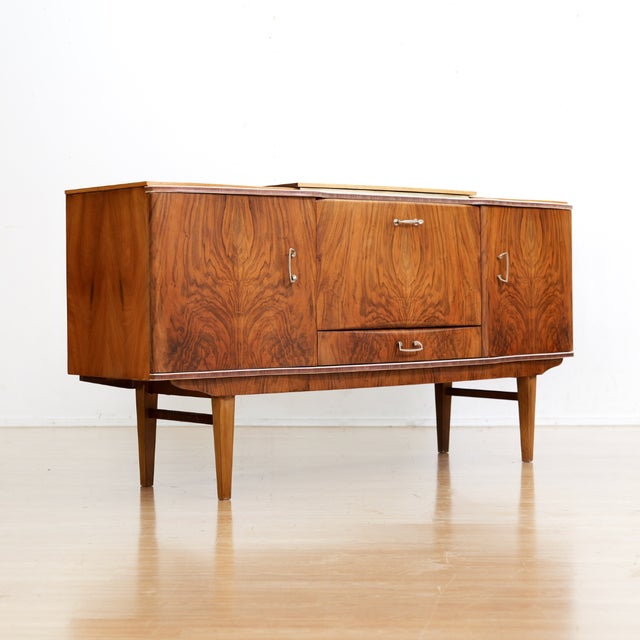 This vintage mid-century cocktail cabinet credenza was designed and manufactured by Beautility Furniture in England during...