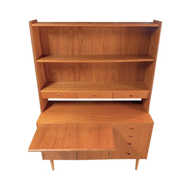 Vintage mid-century modern Scandinavian teak bookcase hutch manufactured in Sweden. Features a slide-out secretary desk or...