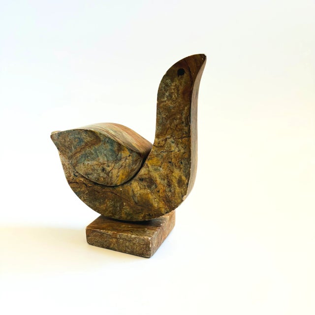 A vintage carved stone bird. Nice simplified modernist shape. Beautiful natural veining and colors to the stone. Signed...