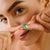 This modern wave-style solitaire ring showcases a stunning 2.43-carat oval-cut emerald, beautifully set in polished 14K...