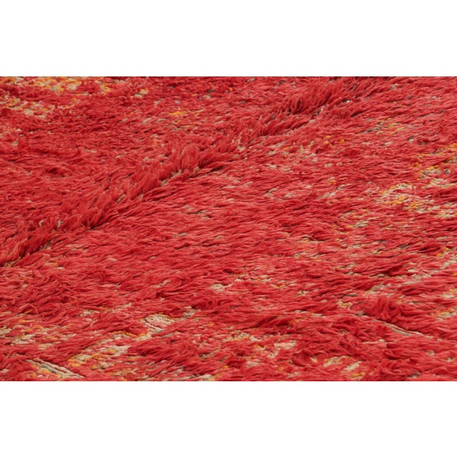 Hand-knotted in wool and originating from Morocco circa 1950-1960, this 7x10 vintage rug is a rare and among the most...