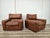 An elegant pair of brown leather armchairs dating back to the 1980s. One of them bears the Moroso label with the Osaka...
