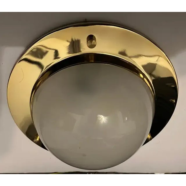 A wonderful Nautical style aged polished brass flush light with a frosted glass dome shade by Italian maker, Azucena....