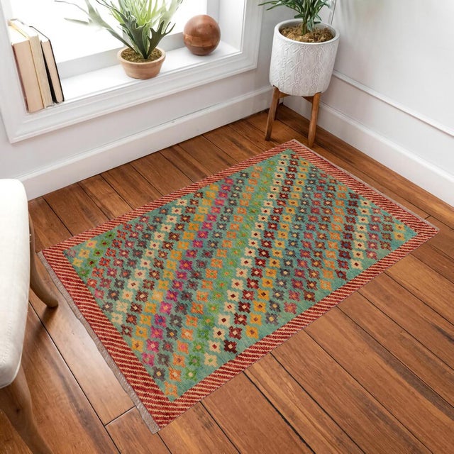 This stunning hand-knotted Afghan Balouchi rug is a captivating addition to any decor. Crafted by skilled artisans, it...