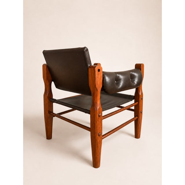 Danish safari lounge chair in faux leather and wood, 1960s.