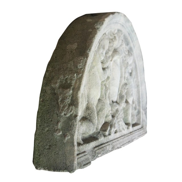 Mid 20th century demilune shaped sculptural wall pediment. Features figural cherubs or angels holding onto a wreath. Very...