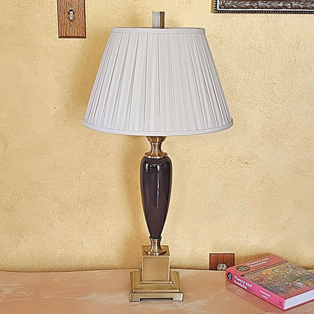 Add a touch of regal sophistication to your interior with this vintage table lamp featuring a sleek dark purple ceramic...