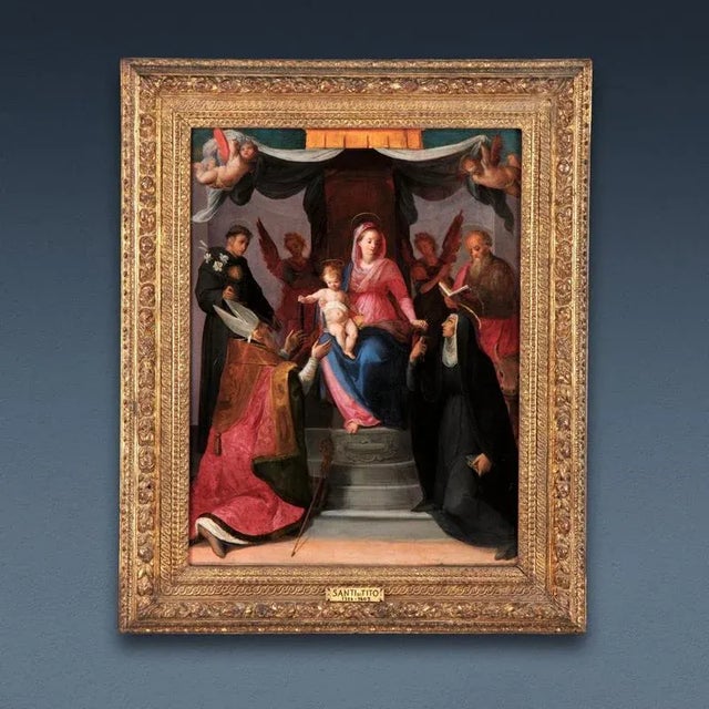 The painting presents the Madonna enthroned with the Child, two praying angels and the saints Nicola da Tolentino,...