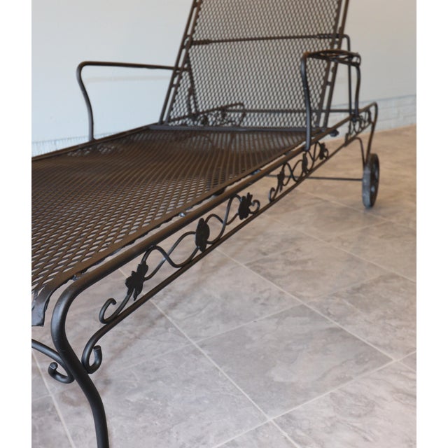 A refined pair of mid-century wrought iron chaise lounges attributed to Woodard Furniture Company, circa 1955–1965. These...