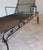 A refined pair of mid-century wrought iron chaise lounges attributed to Woodard Furniture Company, circa 1955–1965. These...