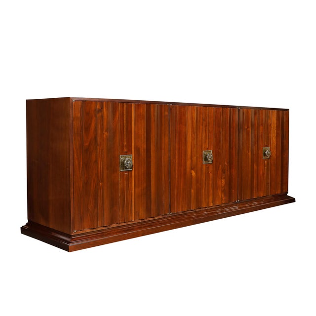 This Mid-Century Modernist sideboard, designed by the celebrated American designer Tommy Parzinger, is a statement piece...