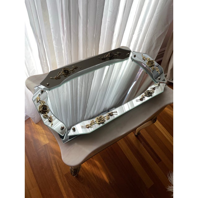 French-style mirrored tray featuring a multi-panel beveled glass construction with a dimensional, sculptural form. The...