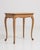 A French side table in oak designed in the Louis XV style, dating to the early 20th century. The form is defined by curved...