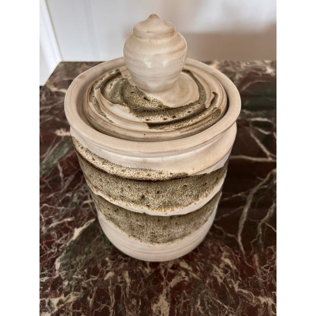 Ceramic vessel with lid. Green and off-white color glazed over. Largest one out of five. Purchased at an estate sale....