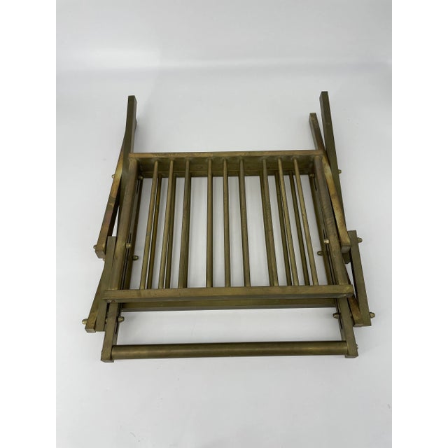 Great Hollywood regency glam from the 1980's! Dark brass magazine rack from Italy. Collapsible to 3" when not in use.