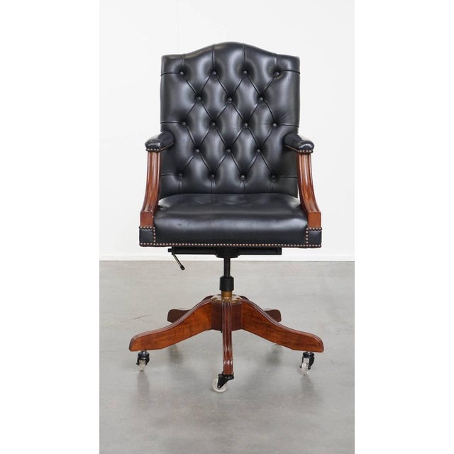 Offered this timeless very dark blue/ black cowhide leather chesterfield office chair on wheels. This nice dark cowhide...