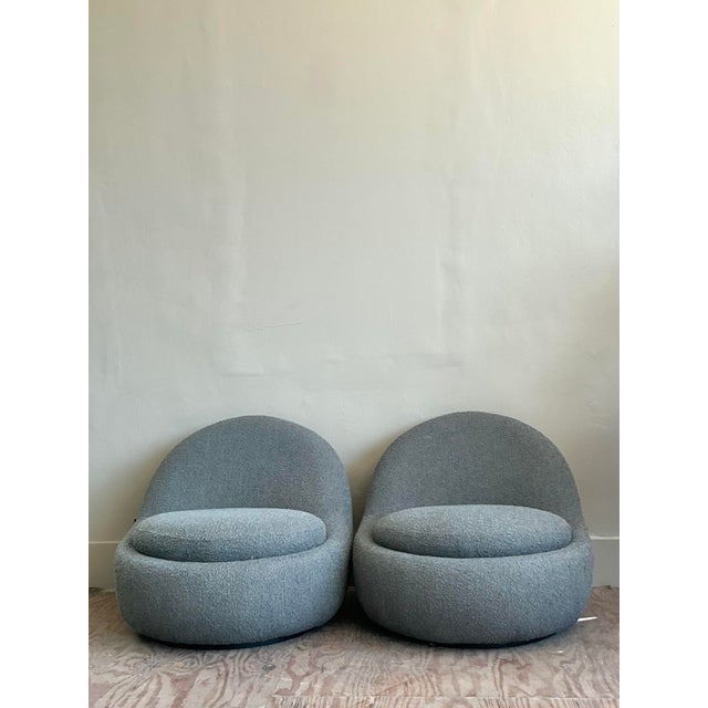 Discover the epitome of comfort and cutting-edge design with this captivating pair of Vintage Boucle Swivel Lounge Chairs....