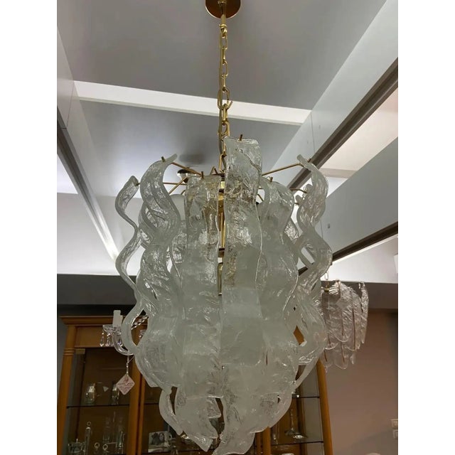 An amazing white frosted murano glass chandelier designed and manufactured in Italy in the Seventies. It's composed by a...