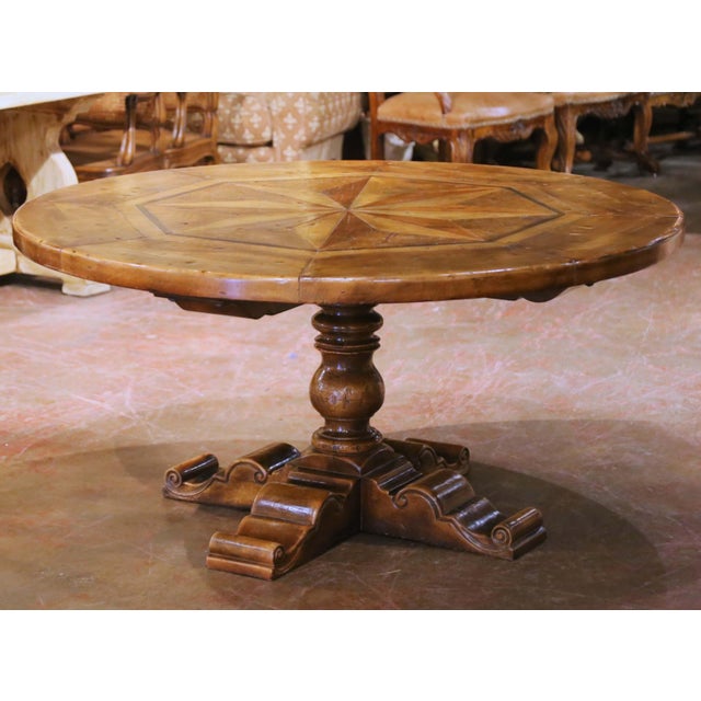 This elegant mid-century French round center table was crafted in the Pyrenees region, circa 1950, in the Louis XIII...