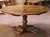 This elegant mid-century French round center table was crafted in the Pyrenees region, circa 1950, in the Louis XIII...