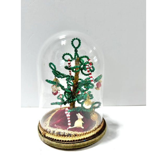 Charming 1970s miniature Christmas tree handcrafted from beads and tiny glass ornaments and displayed beneath a clear...