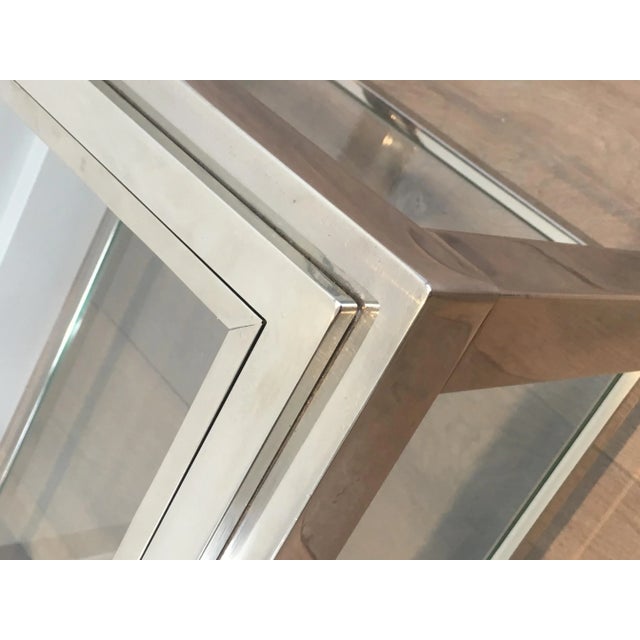 This pair of very nice rectangular side tables are made of chrome with glass shelves. The top glass frame is enframed into...