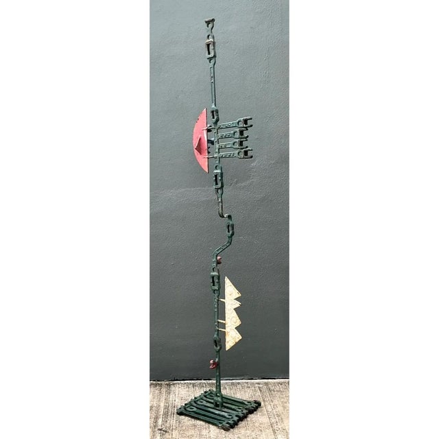 Crafted from iron, this vintage industrial sculpture is a striking example of mid-20th-century welded art featuring a...