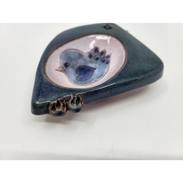 A blue ceramic trinket dish with a concave base, which can also be used as a soap dish. A creation of the cloutier...