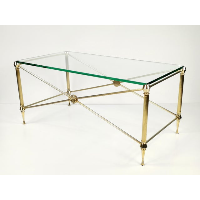 This elegant coffee table features a timeless Neoclassical silhouette that effortlessly blends historical charm with 1960s...
