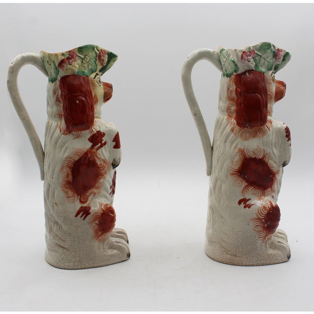 Circa 1860-80 Near Pair of English Staffordshire Red King Charles Spaniel Pitchers. The spaniels sitting up, begging. Gilt...