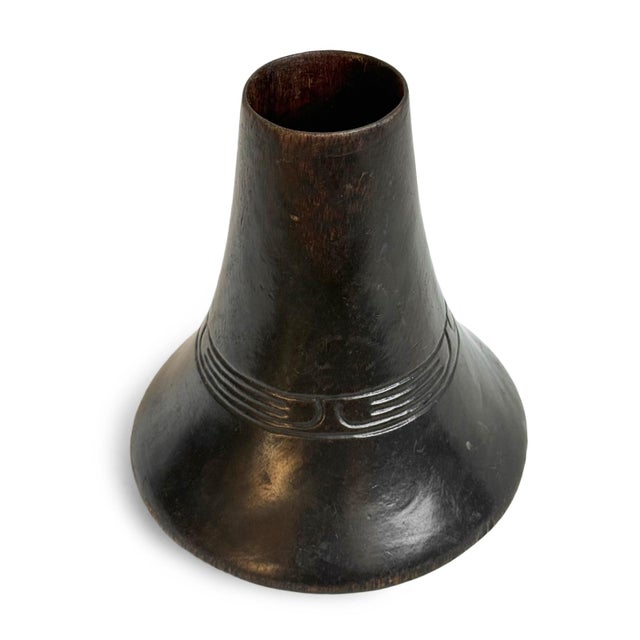 This traditional Ankole wooden milk vessel from Uganda embodies the enduring relationship between pastoral life, skilled...