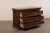 An Italian burl wood veneered chest of drawers from the 18th century. This antique chest from Italy has a rectangular-...