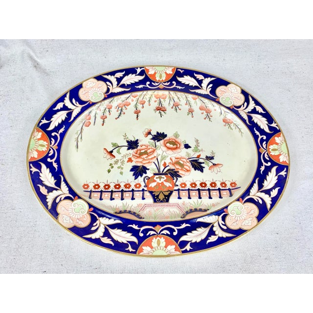Huge antique ironstone platter. Striking colors and beautiful detailing. Small repair on edge that does not go through....