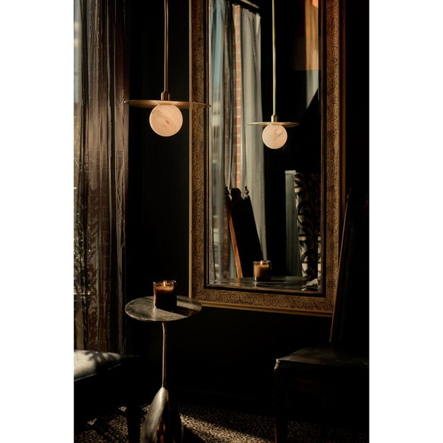 The Rhoads Pendant captures the collection’s sculptural balance in its most distilled form. A single alabaster-glass globe...