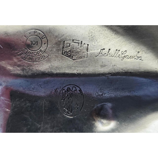 The Achille Gamba Pewter Leaf Dish Tray is a unique and intricate collectible piece made of high-quality pewter. This dish...