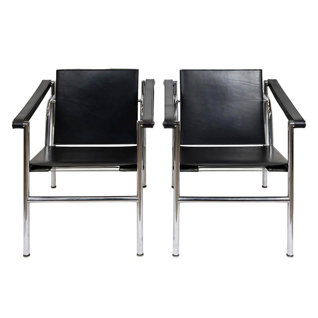 Pair of vintage LC1 black leather chairs designed by Le Corbusier circa 1928's and manufactured in 1960's. Engraved serial...