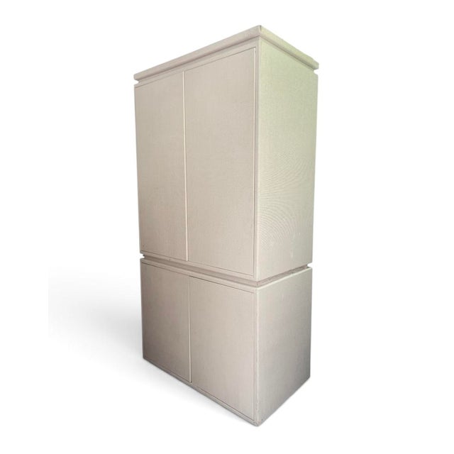 Sophisticated texture meets exceptional storage in this versatile raffia-clad cabinet designed to disappear beautifully...