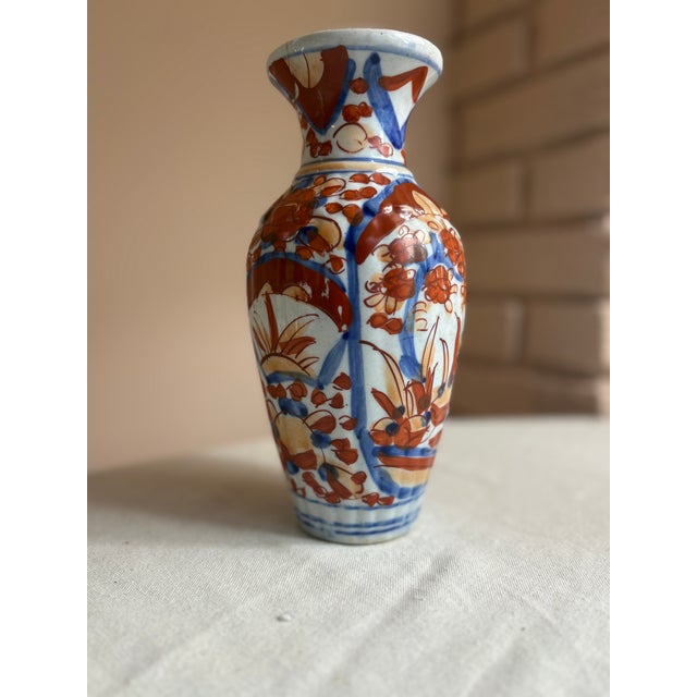 Japanese Imari porcelain vase in classic baluster form with a flared rim. Hand-painted. Dates to the late 19th century...