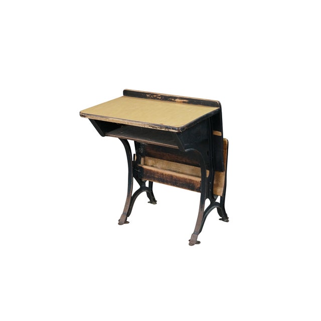 This antique T. Kundtz Co. classroom school desk (circa 1900) features a classic integrated tandem design combining a...