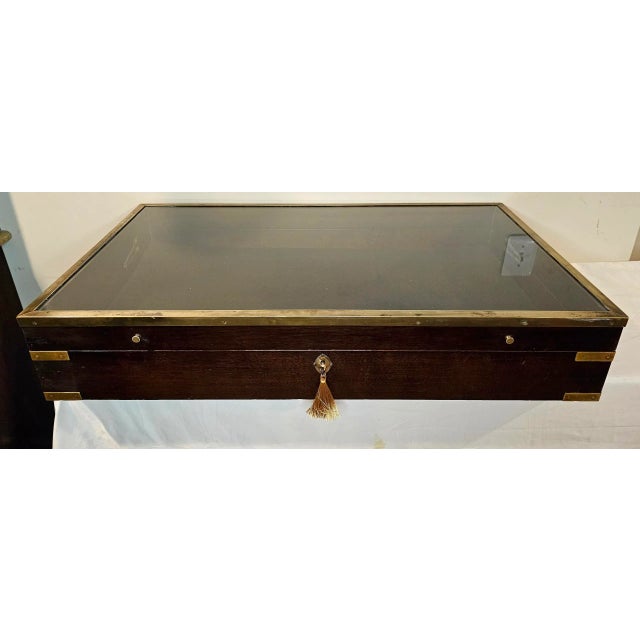 This Large Vintage Countertop Campaign-style Display Case is elegant and timeless, with warm, dark-stained wood and unique...