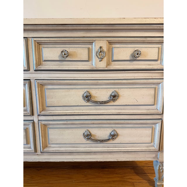 The DIXIE FURNITURE French Country VIntage Dresser is a charming six-drawer dresser with a classic French Country style....