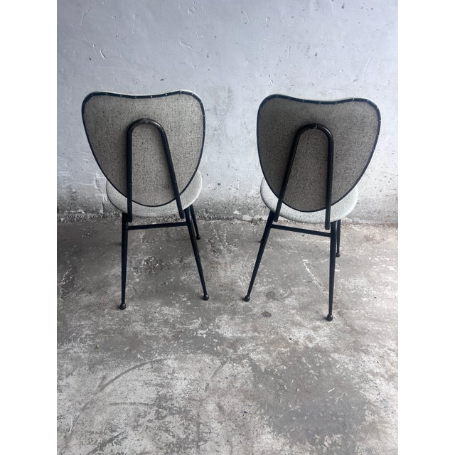 The chairs feature Hitier’s characteristic use of a slender black tubular steel frame, combined with softly upholstered...