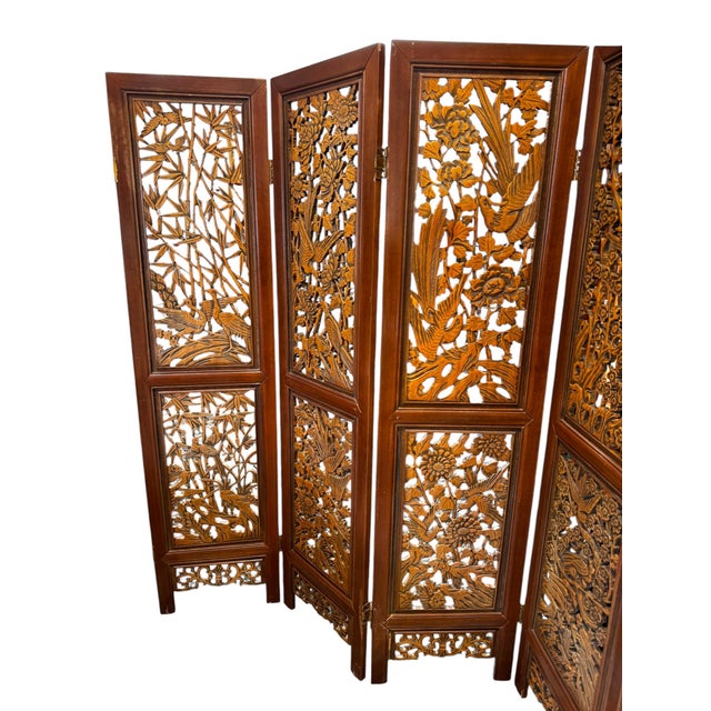 A beautifully detailed vintage wooden room divider featuring intricate hand-carved panels with birds, florals, and bamboo...