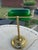 Vintage classic banker’s lamp features the iconic emerald‑green glass shade paired with a round brass‑tone metal base and...
