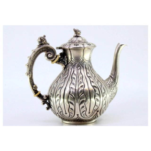Silver Coffee Pot with Relief Engraving and Handle Lid with Dragon Figure, in Very Good conditions. Designed 1890 to 1919...