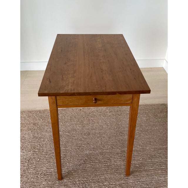 Elegant Thomas Moser end table in solid cherry featuring a single drawer and refined minimalist design. This piece notable...