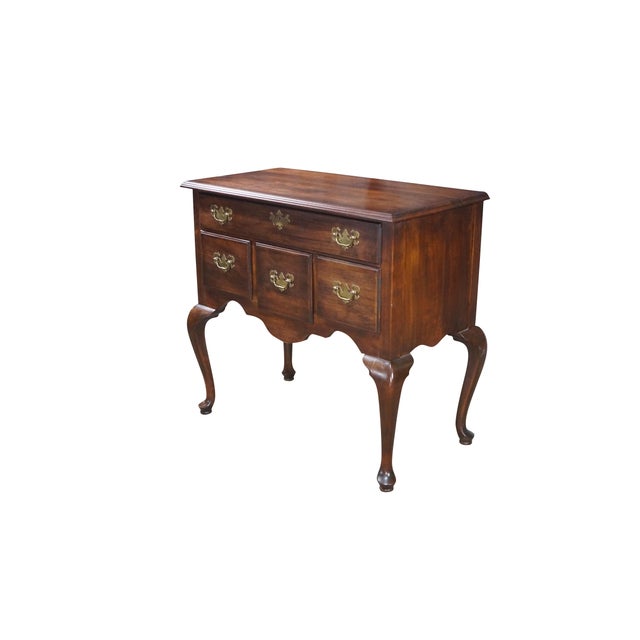 This handsome 20th-century Queen Anne style lowboy chest is meticulously crafted from solid cherry wood, showcasing a...