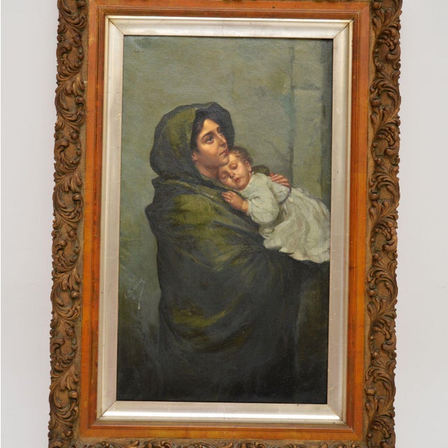 A beautifully executed antique Dutch oil painting in a gilt wood frame, depicting a mother and baby, dating from around...