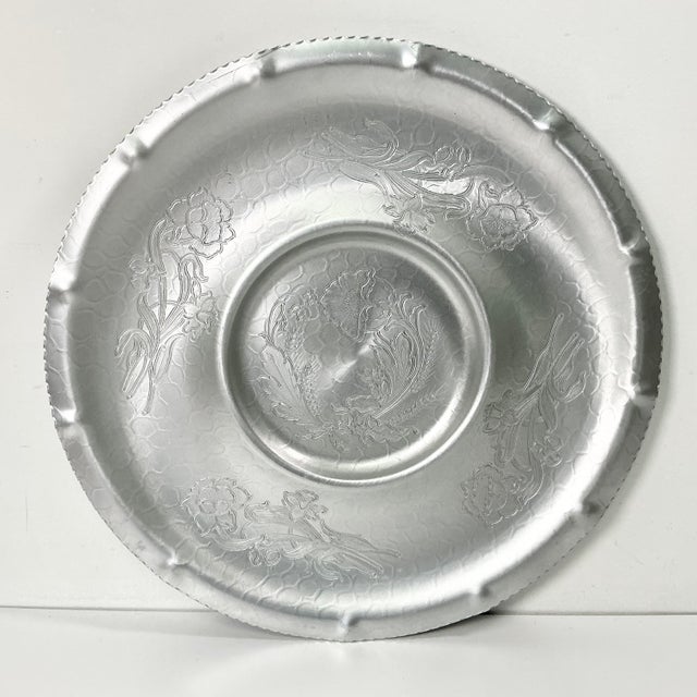 This 1950s Aluminum Serving tray is hand-wrought and etched with botanical Irises and leaves. It’s a large round serving...